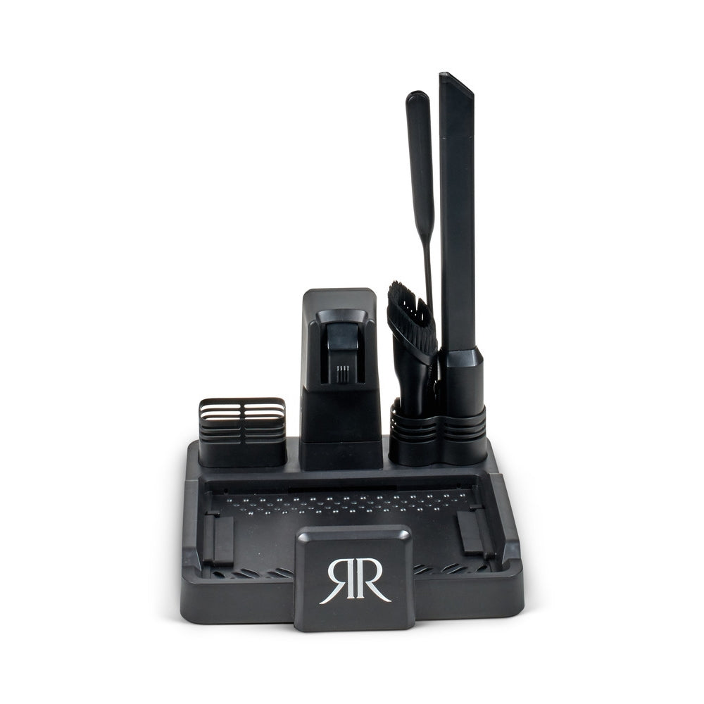 Riccar R70 charging and cleaning base with the crevice tool and brushes stored